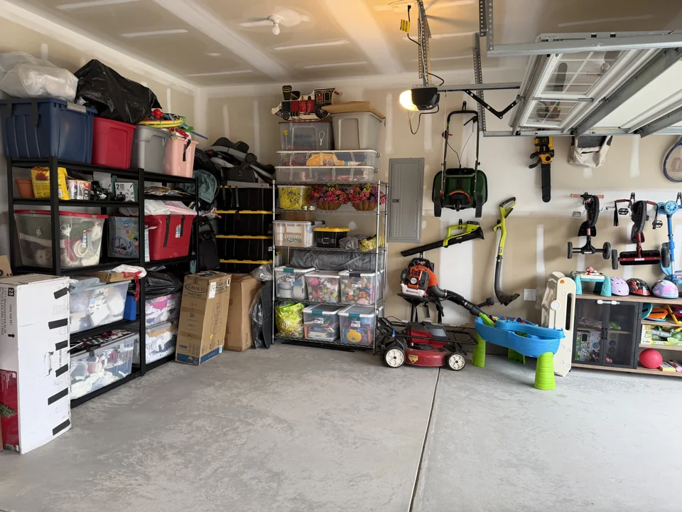 Bins on shelving and tools on wall hooks after organizing